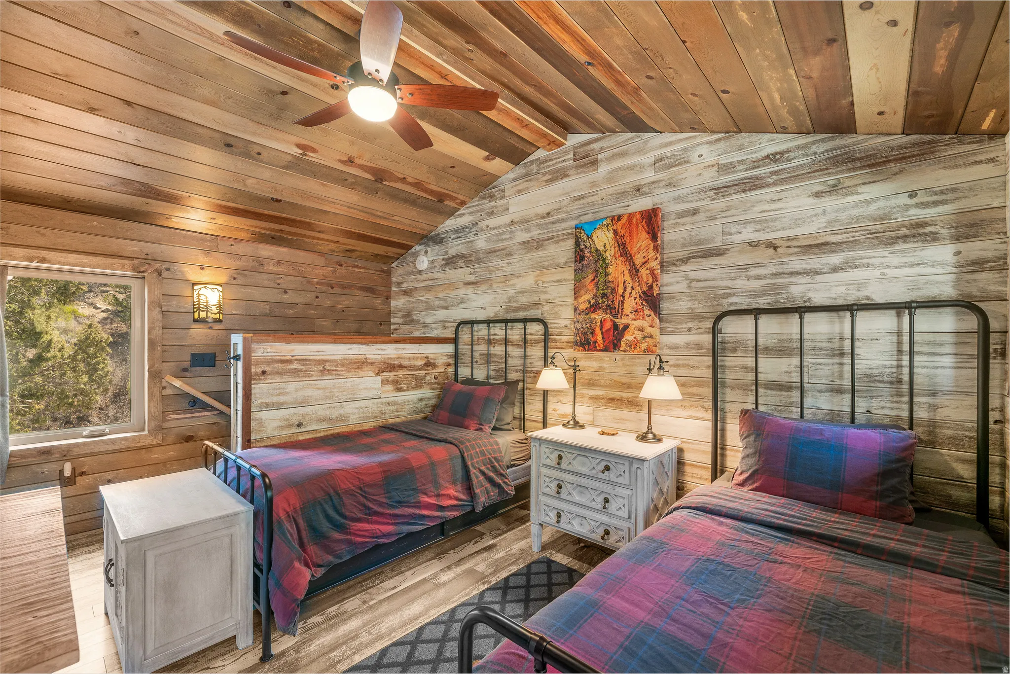 Vaulted wood-paneled ceiling with a central fan light fixture