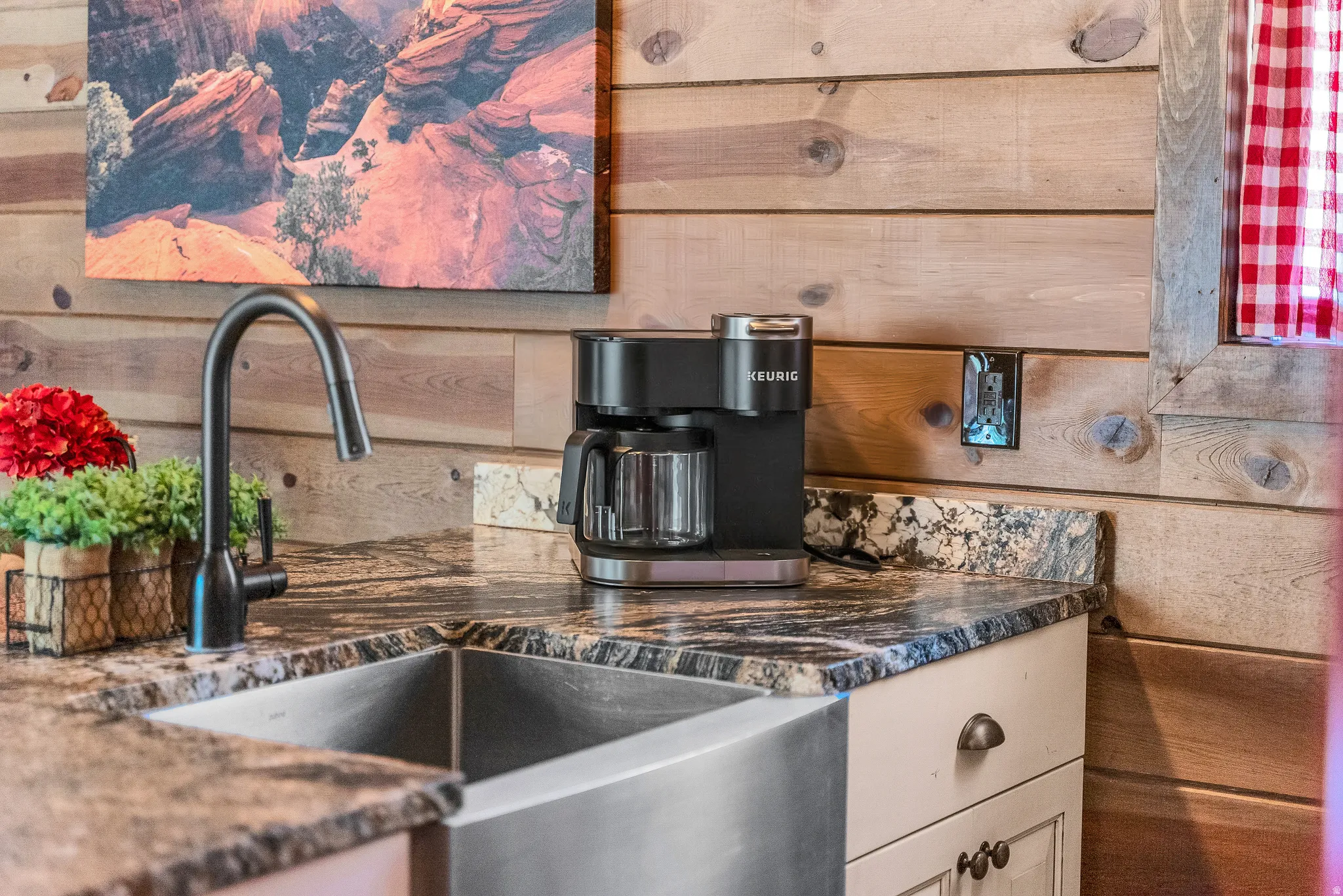 Stainless steel farmhouse sink featuring a gooseneck matte black faucet