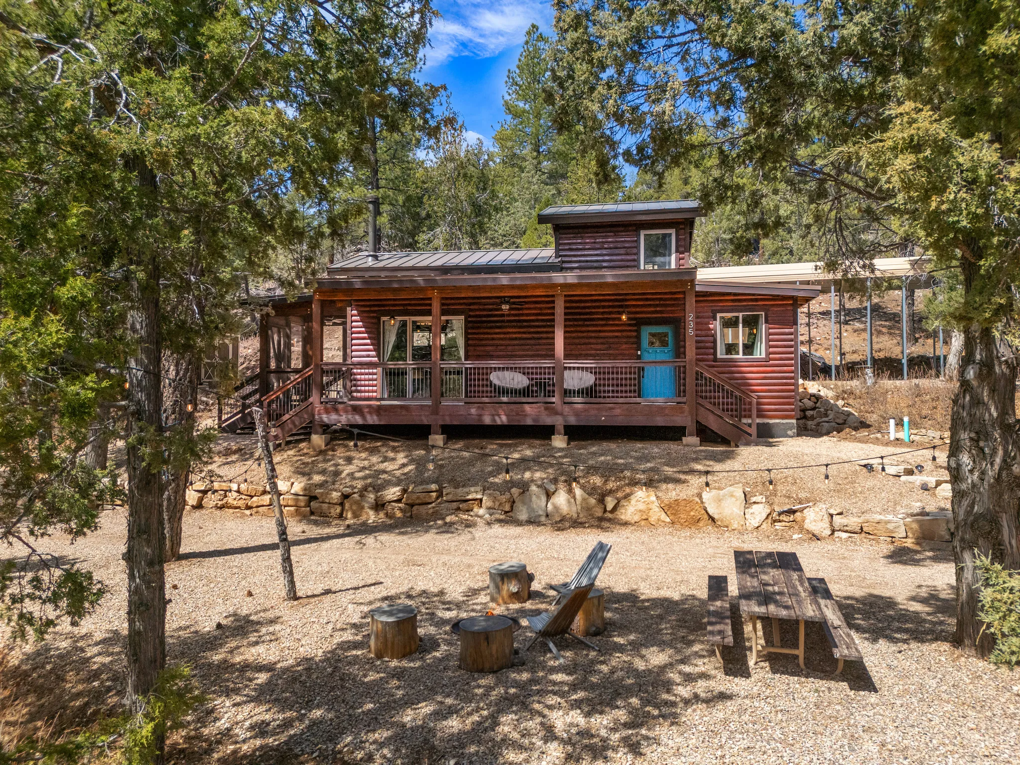 Rustic cabin exterior featuring natural wood siding and a covered front porch