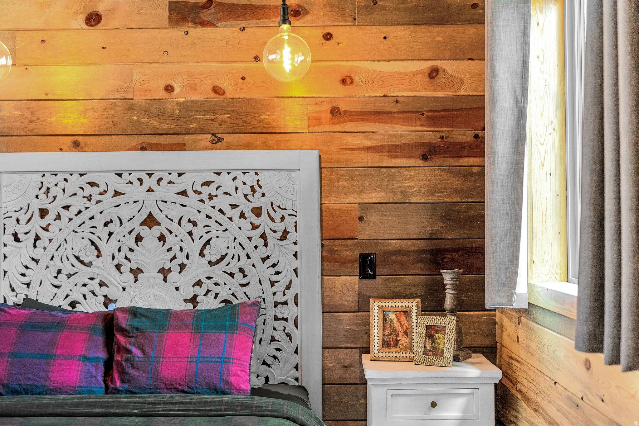 Wood plank wall paneling with a carved white headboard