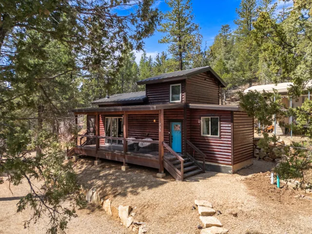 Log-style siding exterior with a metal roof