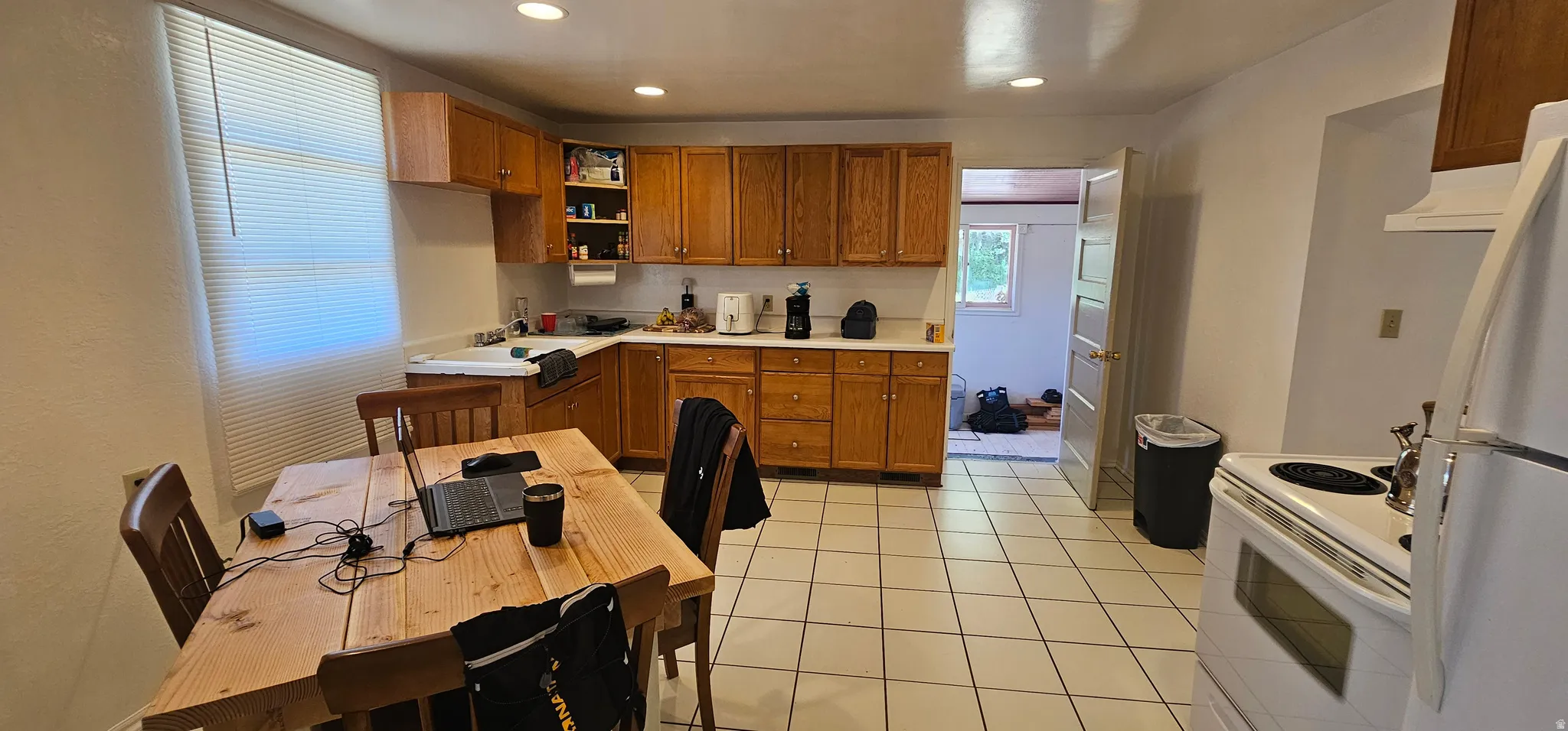 Kitchen featuring tile flooring, light wood cabinetry, white countertops, and recessed lighting
