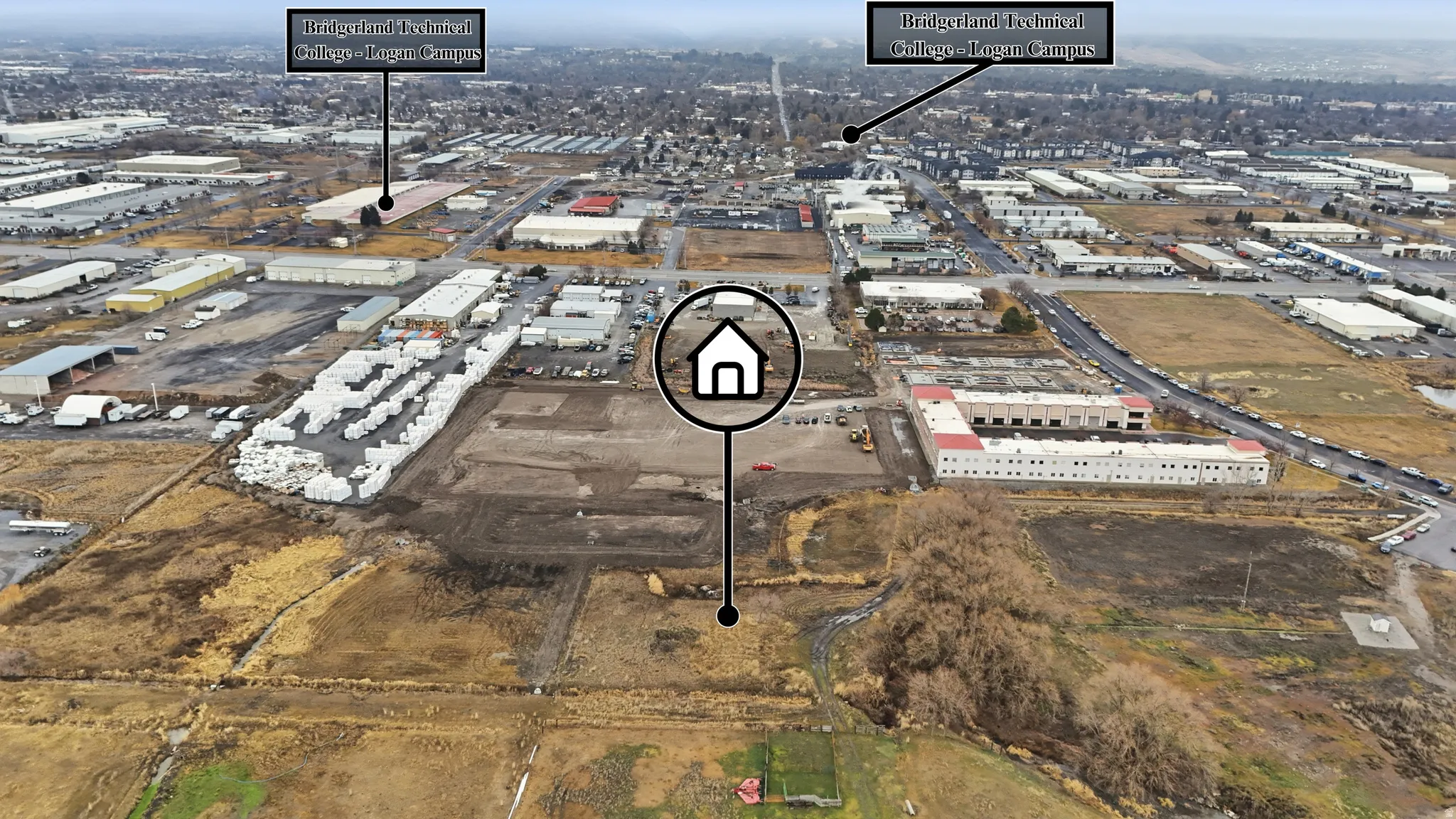 Expansive aerial perspective showcasing a large undeveloped parcel of land, surrounded by established commercial and industrial properties