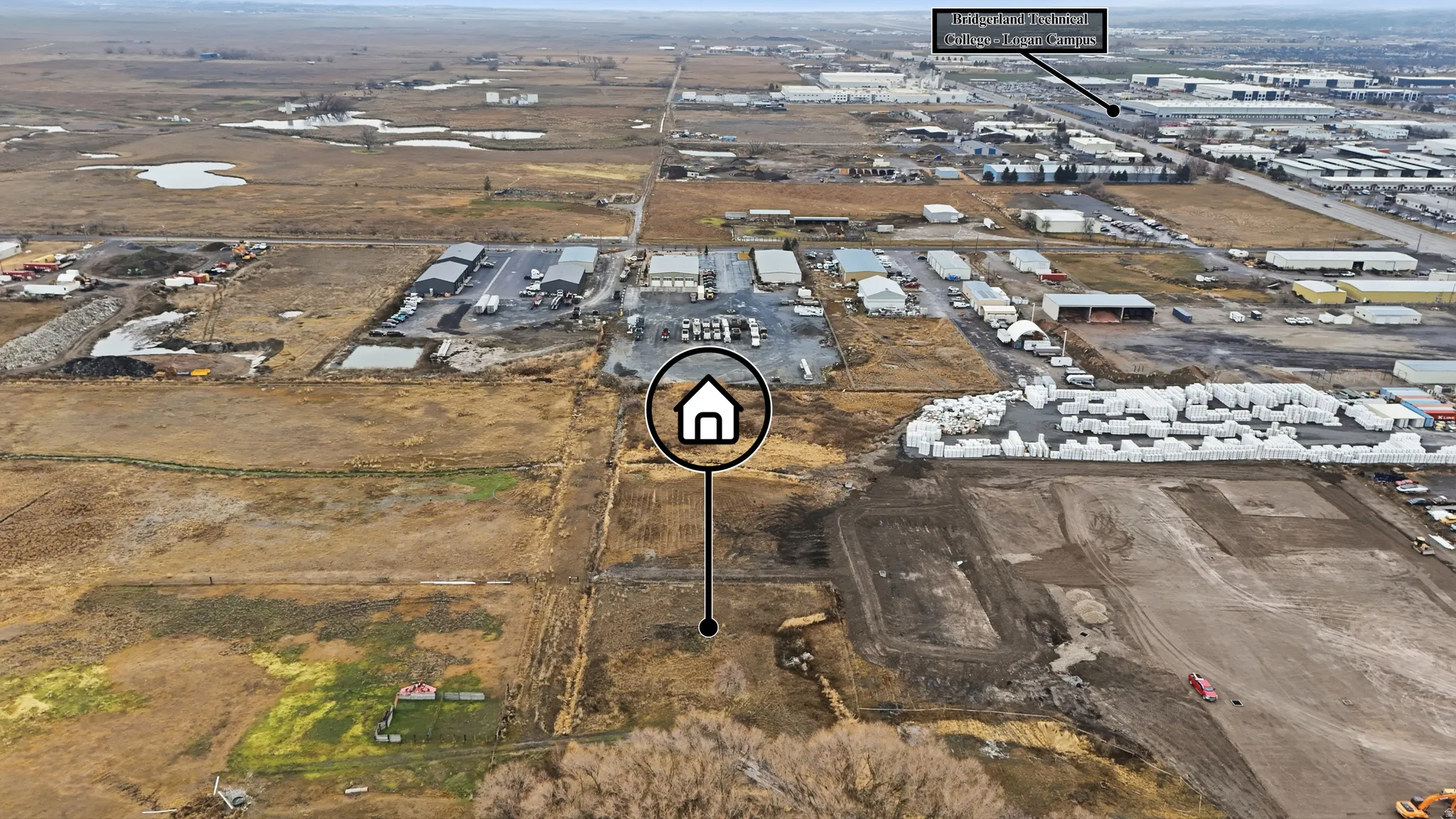 Expansive undeveloped land parcel with surrounding commercial and industrial properties