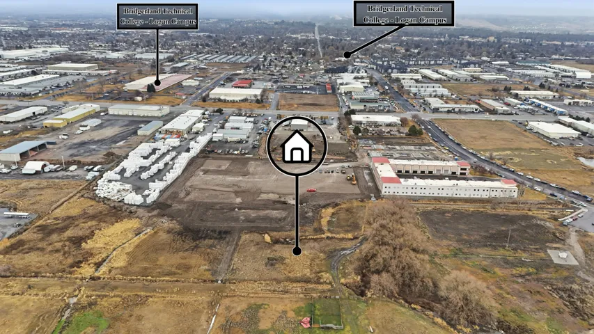 Expansive aerial perspective showcasing a large undeveloped parcel of land, surrounded by established commercial and industrial properties