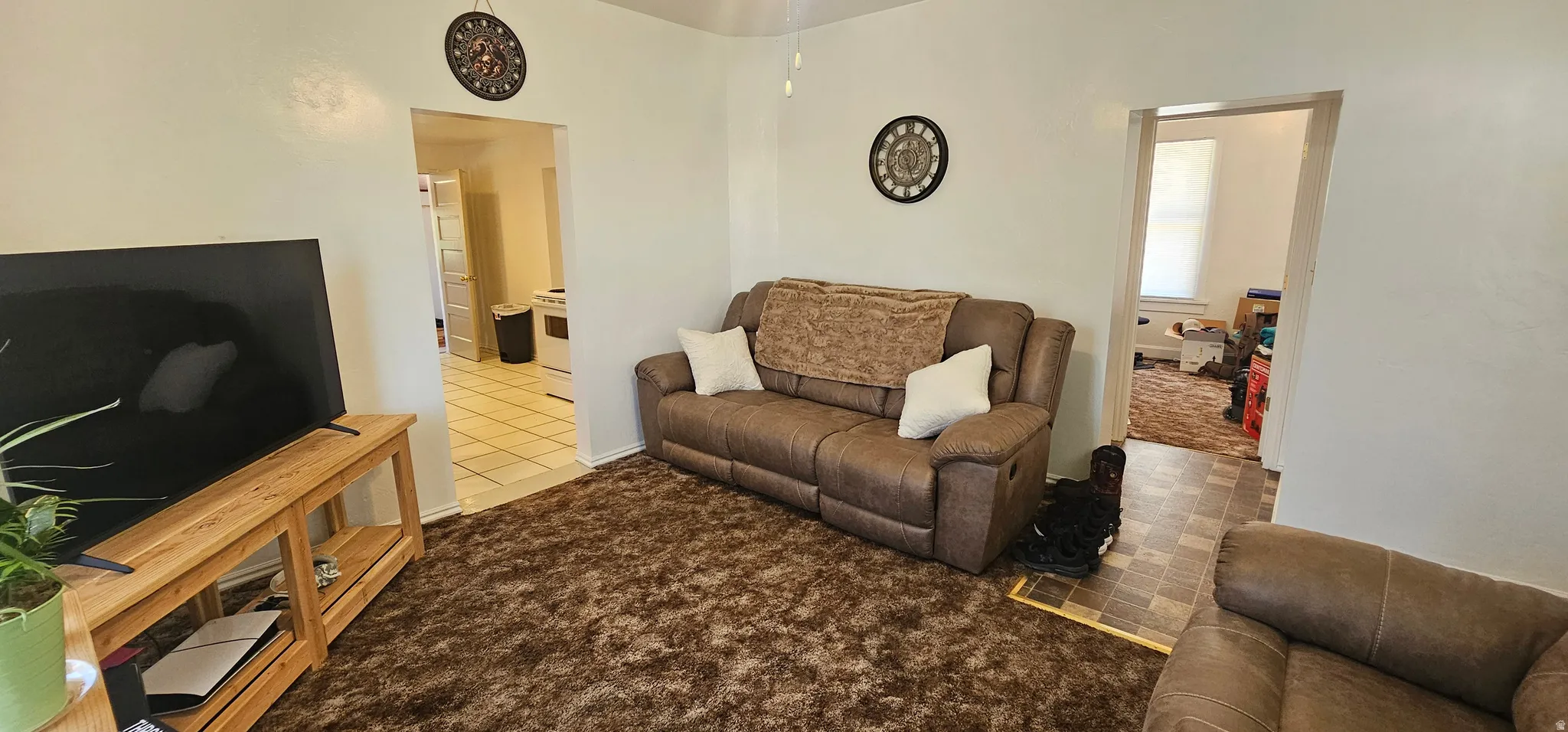 Bright interior space featuring light-colored walls and a ceiling fan