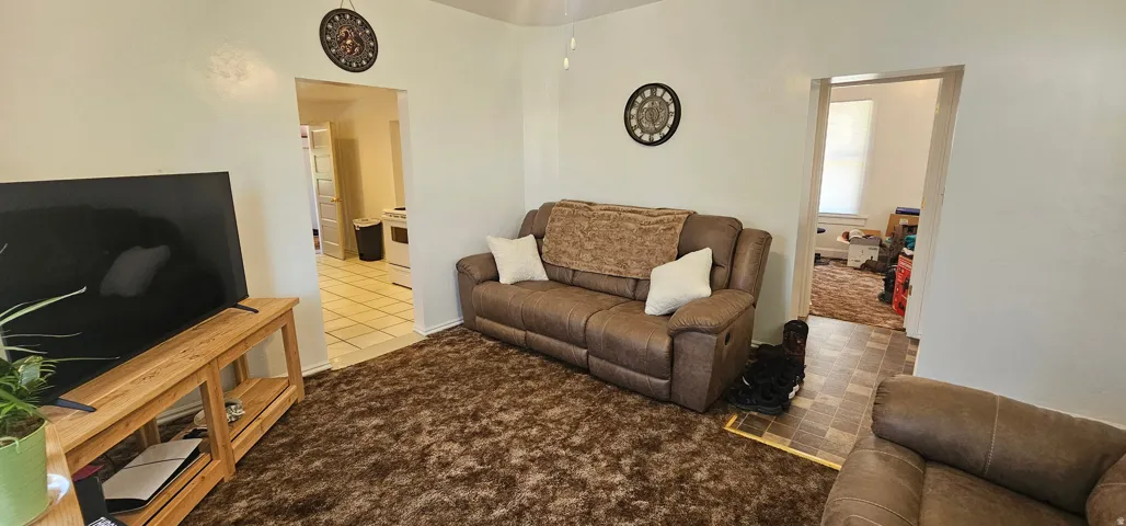 Bright interior space featuring light-colored walls and a ceiling fan