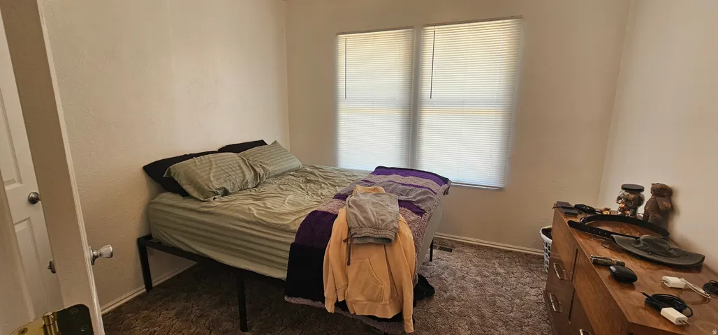 Room featuring textured walls and brown carpet flooring