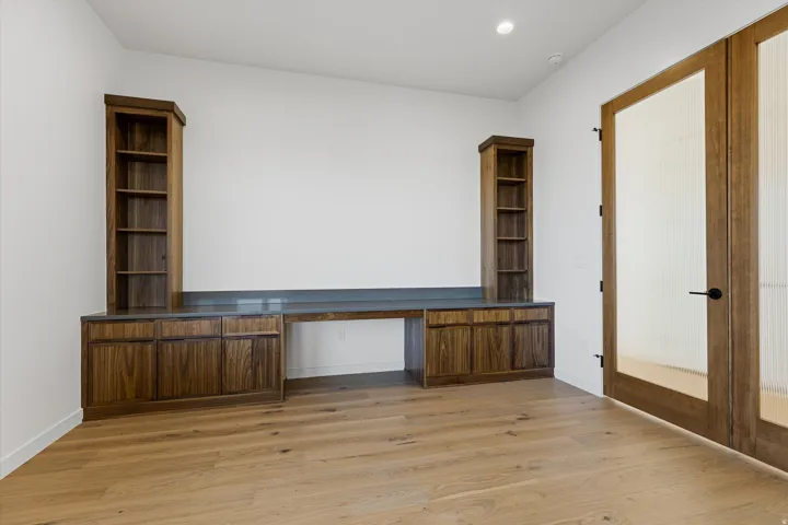 Built-in wood cabinetry with a dark countertop and integrated desk space