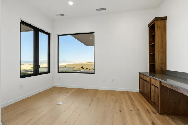 Room featuring wood-finish flooring, recessed lighting, and white baseboards