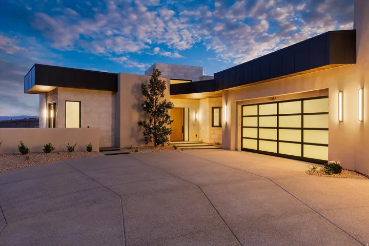 Contemporary exterior with a modern garage door featuring frosted glass panels and black framing
