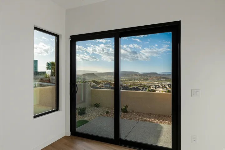 Sliding glass door opening to an outdoor patio with a gravel and concrete surface