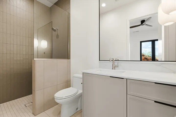 Modern bathroom featuring a vanity with a rectangular undermount sink, a white countertop, and contemporary cabinetry