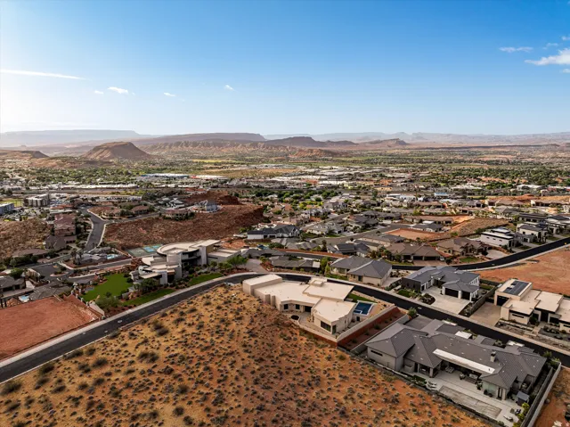 Expansive desert landscape featuring numerous residential properties and mountainous terrain