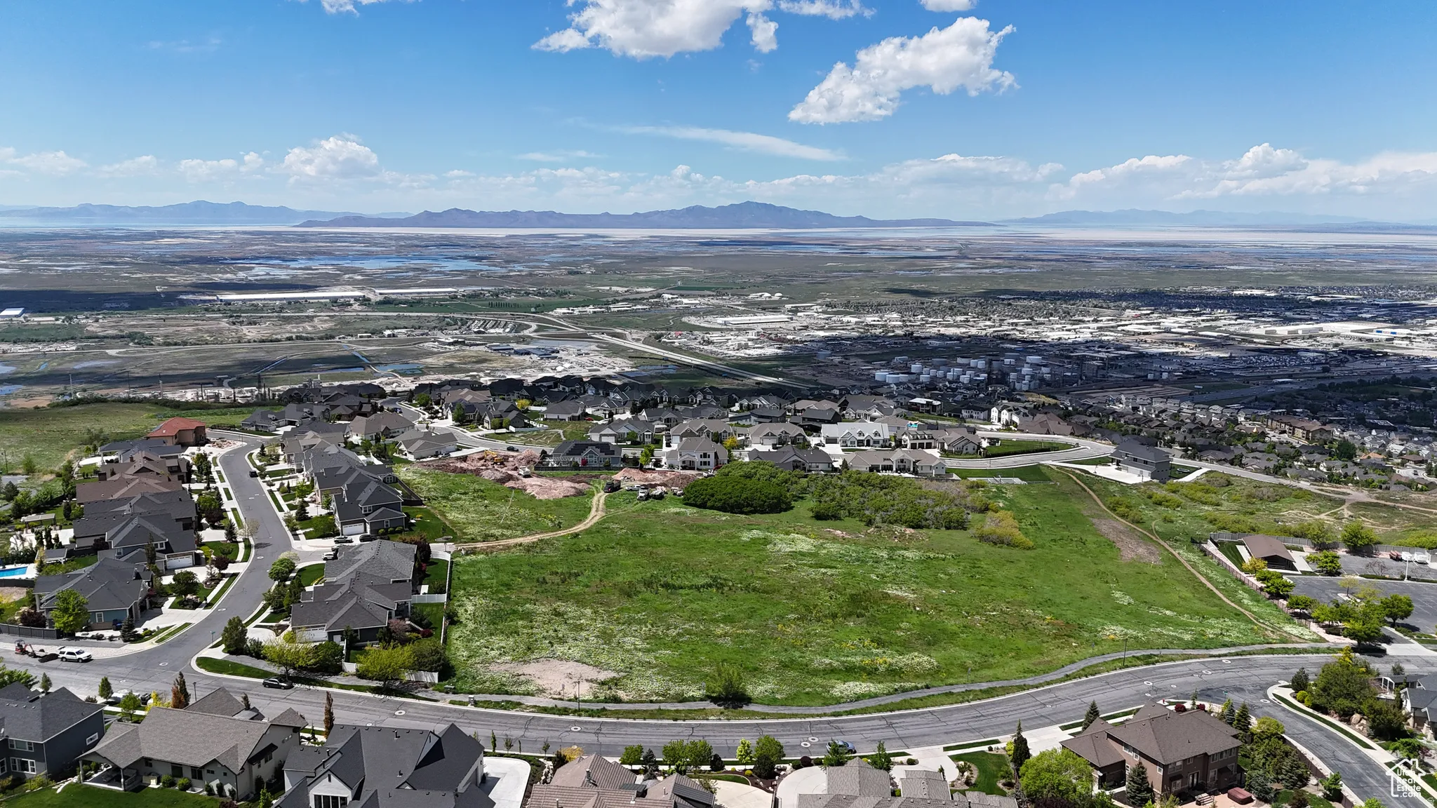 Expansive undeveloped land parcel surrounded by established residential properties