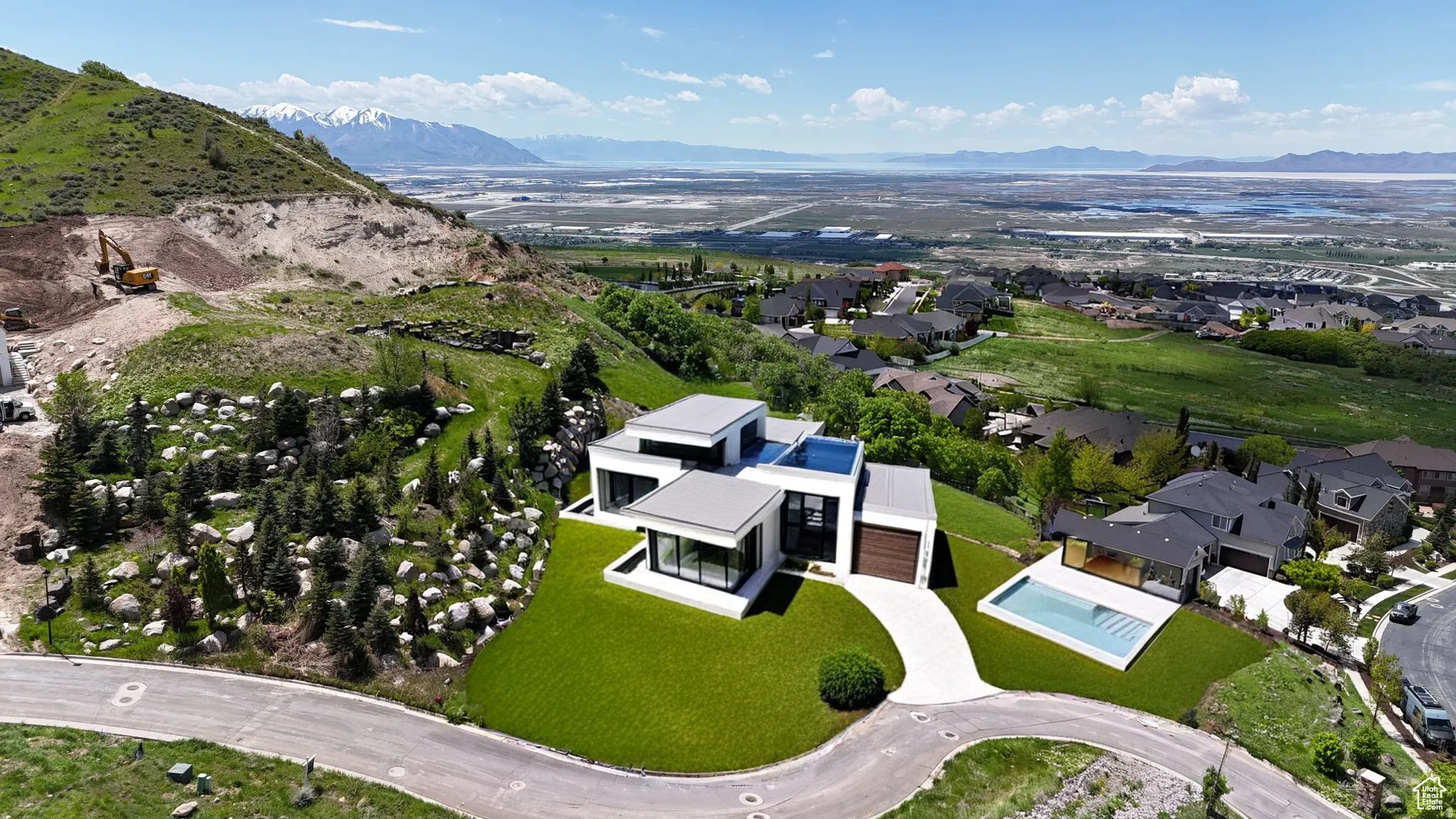 Modern architectural residence featuring a terraced design, flat roofs, and expansive windows