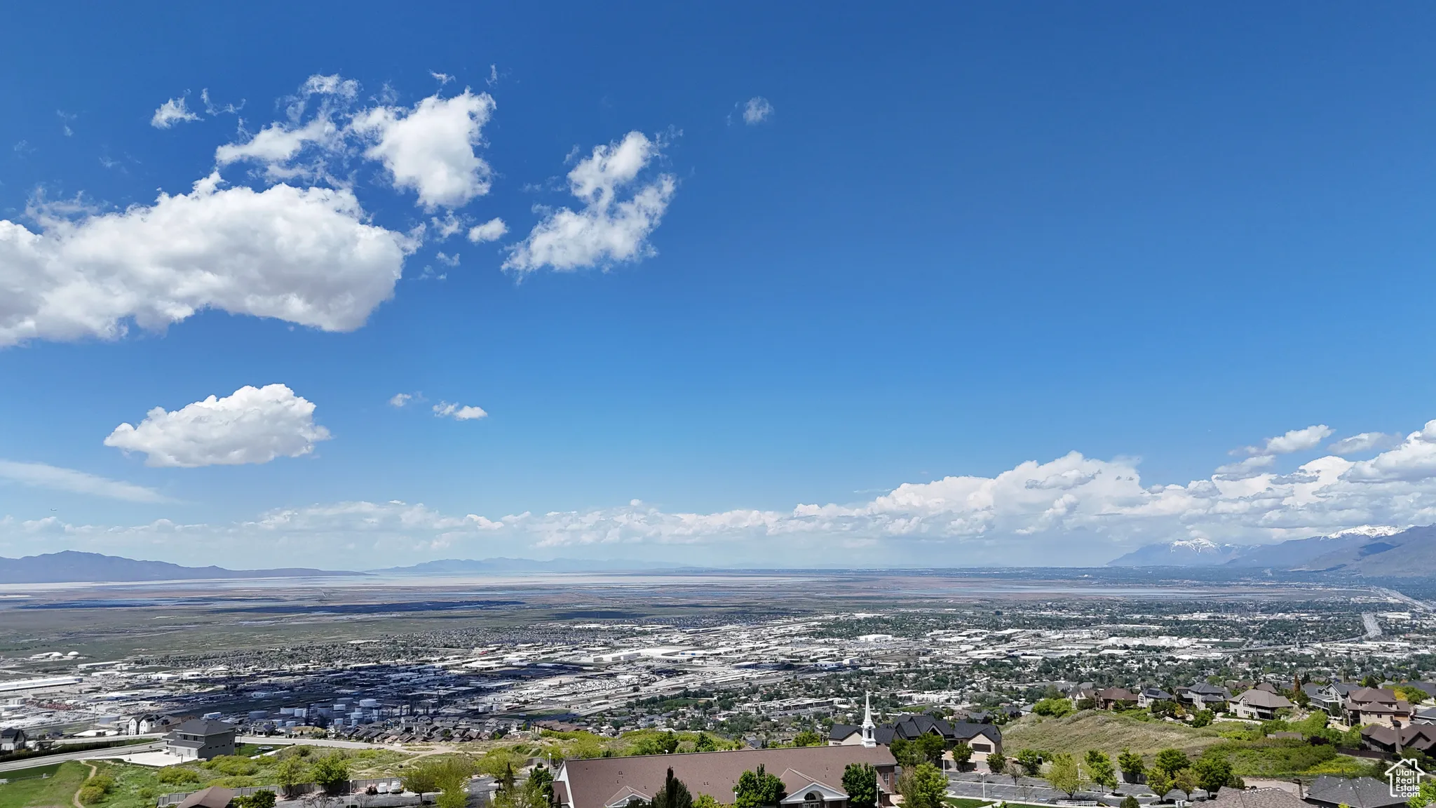 Expansive regional landscape featuring distant mountains and a broad valley