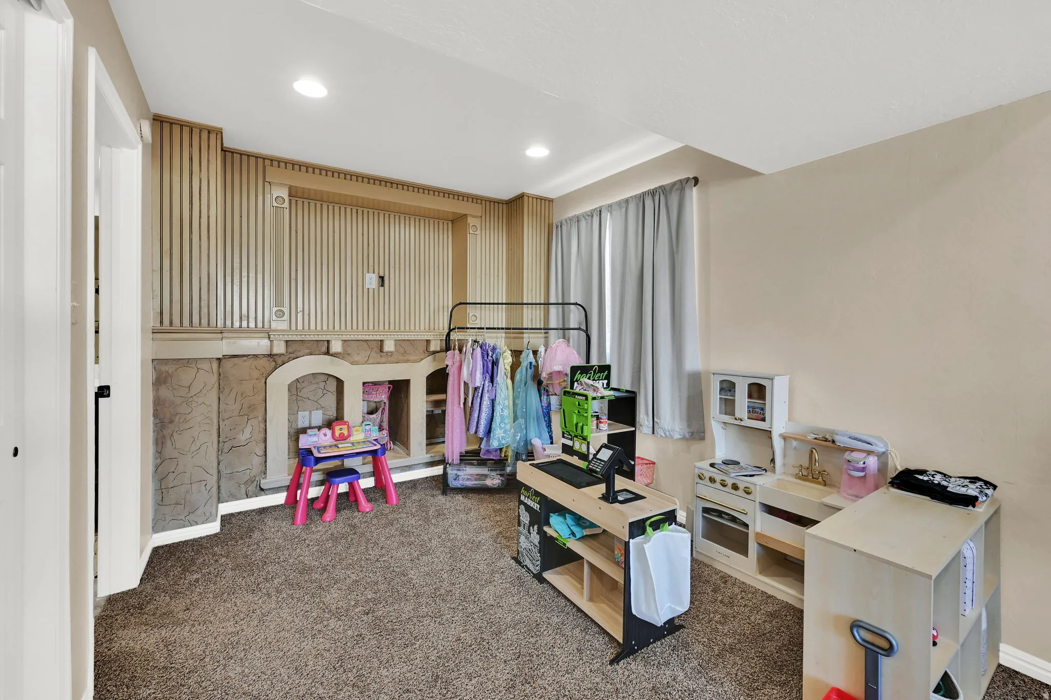 Wall-to-wall carpeting and recessed lighting define this versatile room