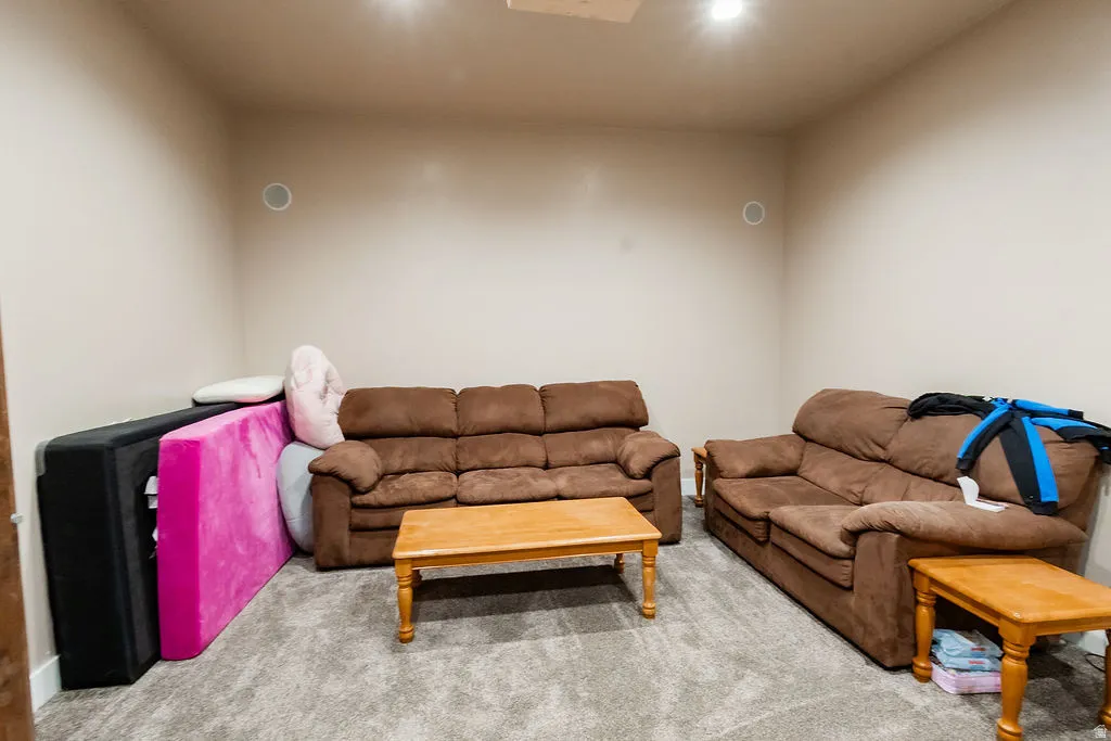 Spacious room with neutral wall paint and gray textured carpeting