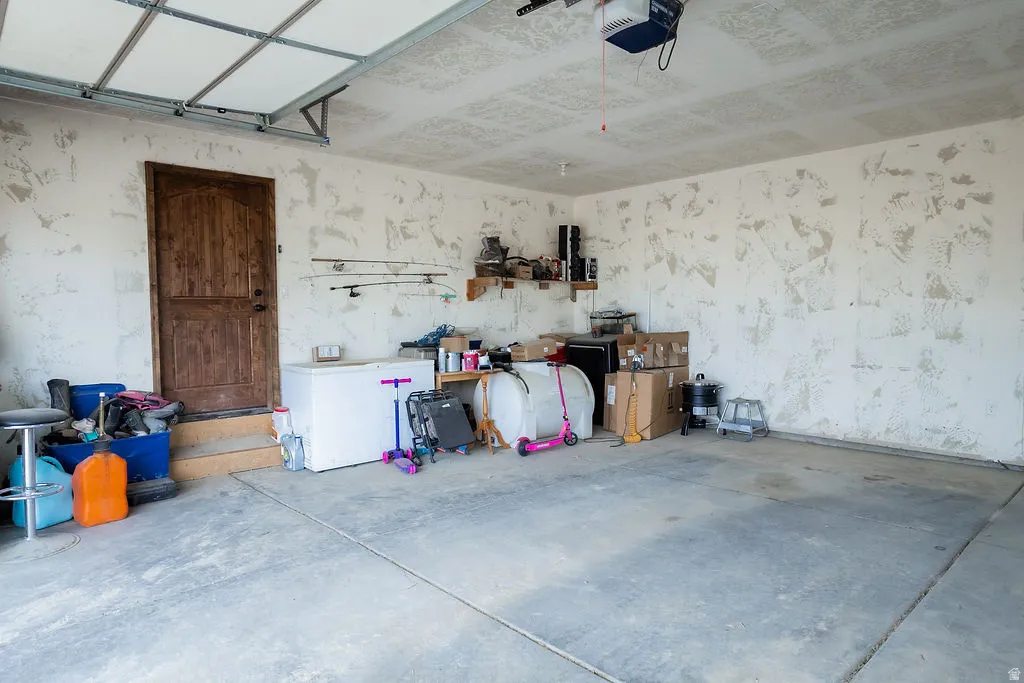 Spacious garage featuring concrete flooring and textured walls