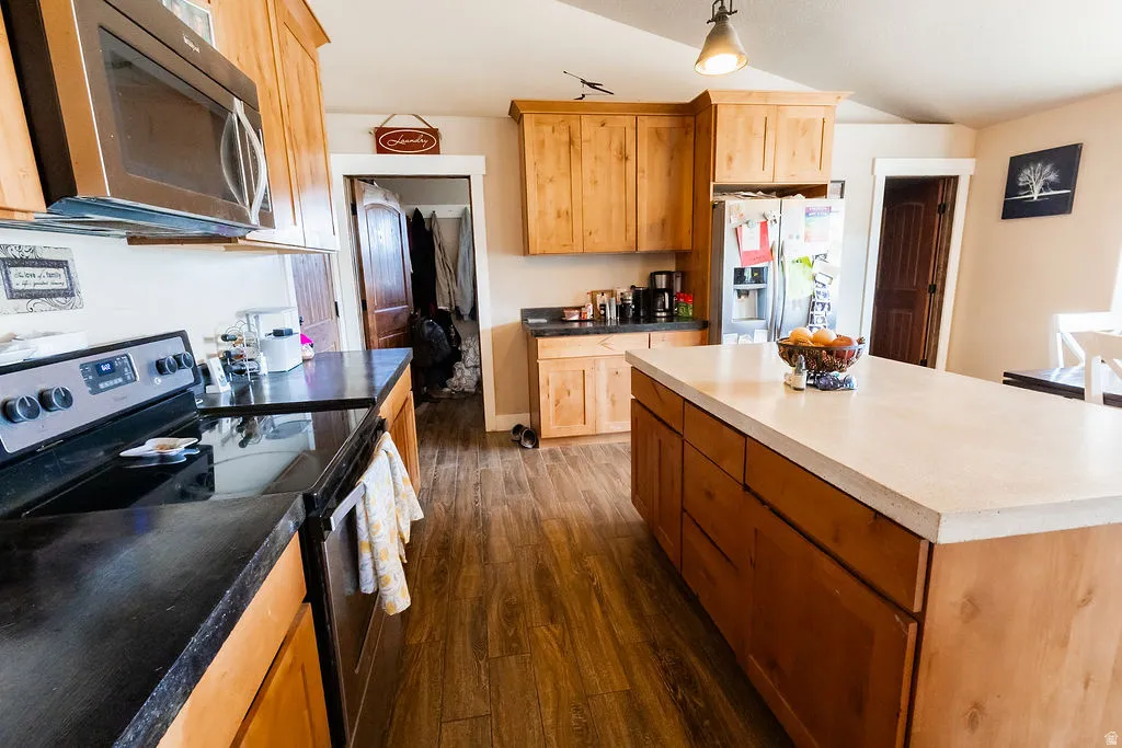 Kitchen featuring wood-finish flooring and light wood cabinetry