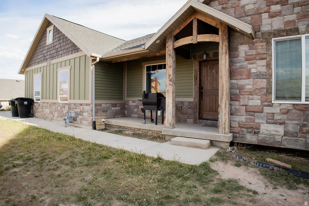 Stone and siding exterior with a covered entry