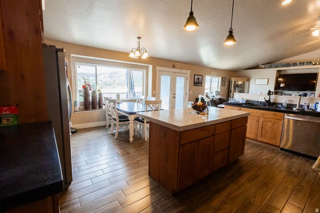 Kitchen featuring wood-finish flooring, a central island with a light-colored countertop, and recessed lighting