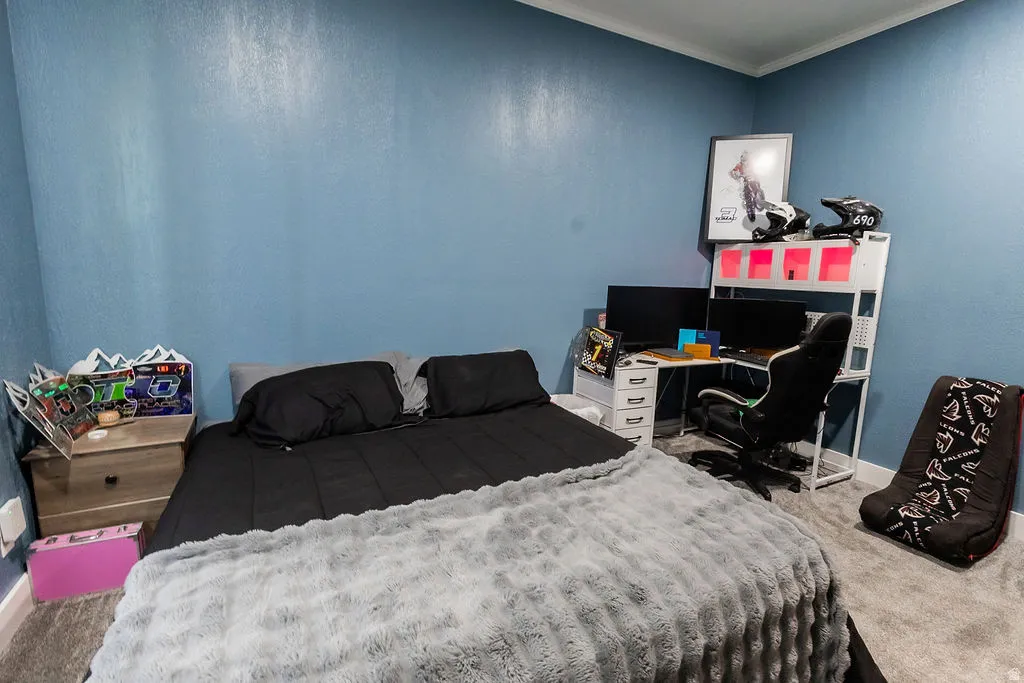 Bedroom featuring blue textured walls and light gray carpet flooring