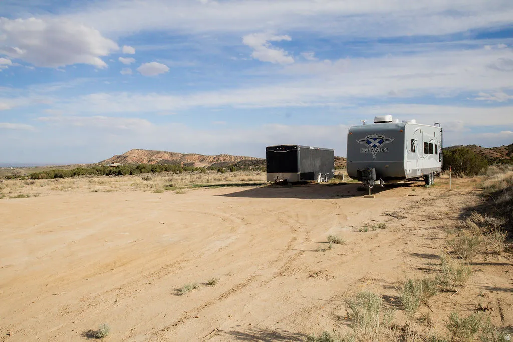 Expansive undeveloped land featuring a dirt surface and sparse desert vegetation