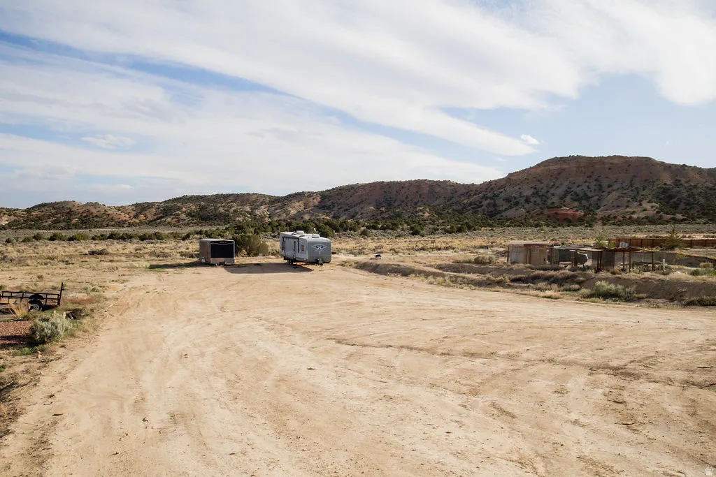 Expansive desert landscape featuring natural terrain and distant mountains