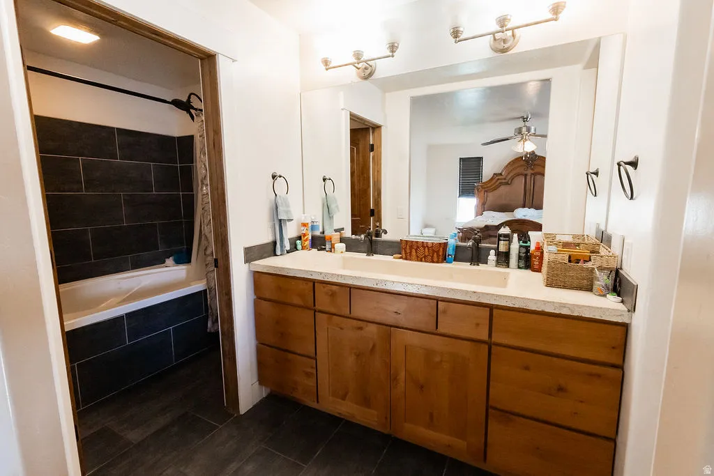Double vanity with undermount sinks, light-toned countertop, and wood-finish cabinetry