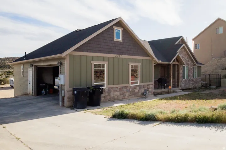 Ranch-style exterior with stone veneer and horizontal siding accents