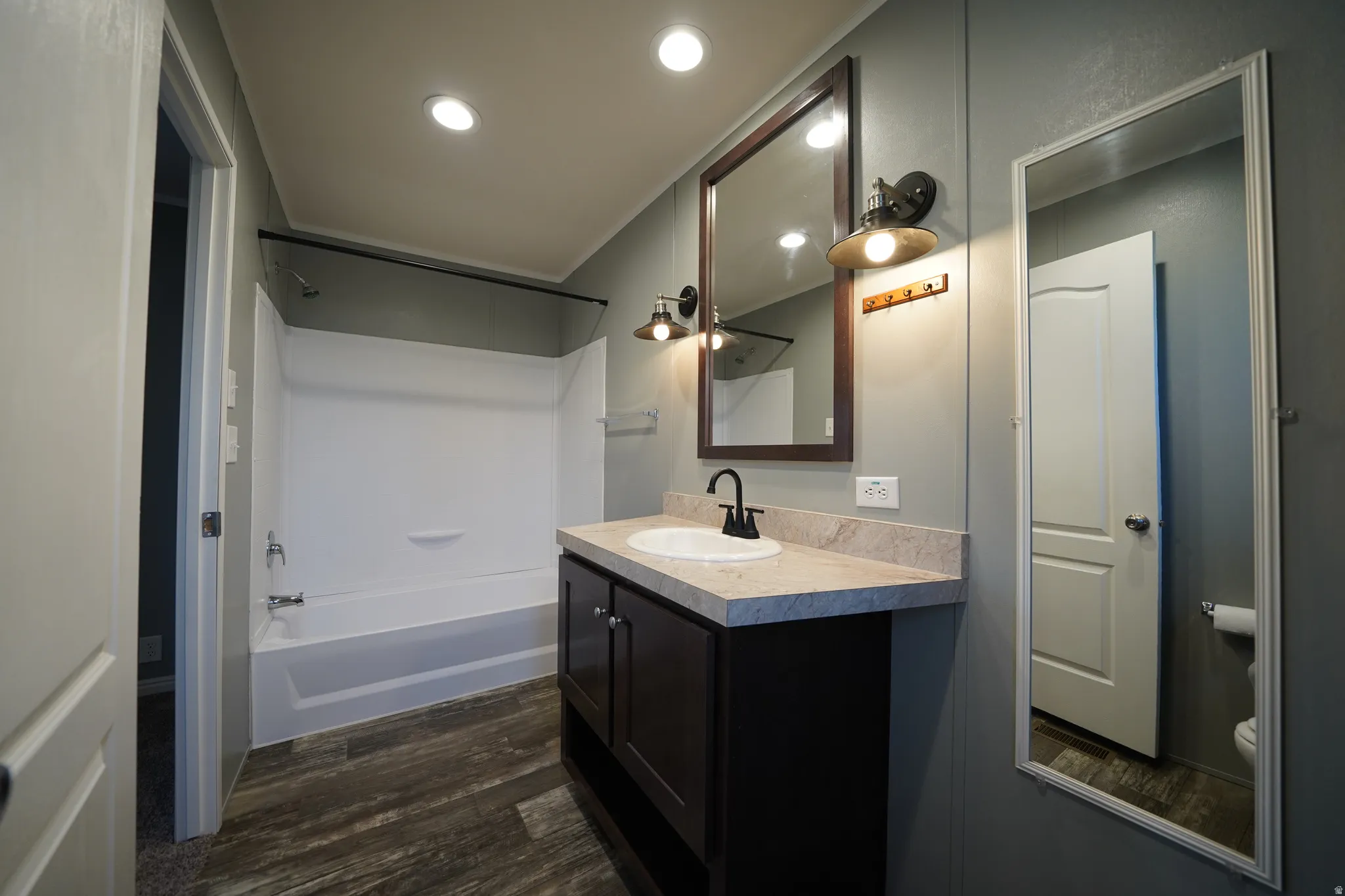 Primary Bathroom featuring a dark wood-finish vanity with a light-toned countertop and an integrated sink