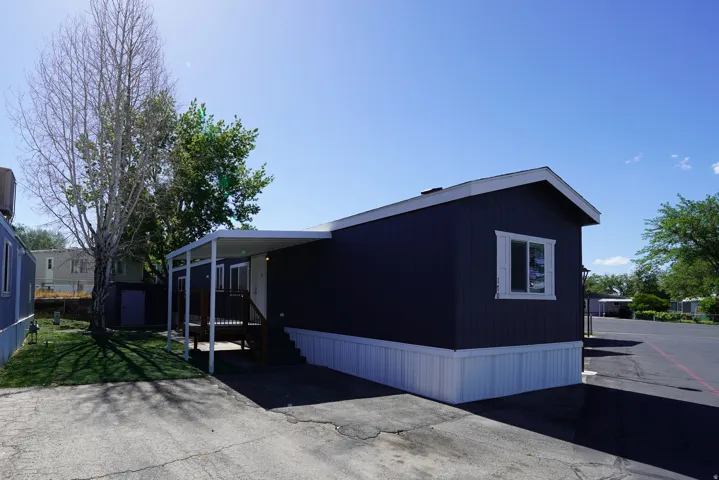 Dark-hued siding with white trim and foundation