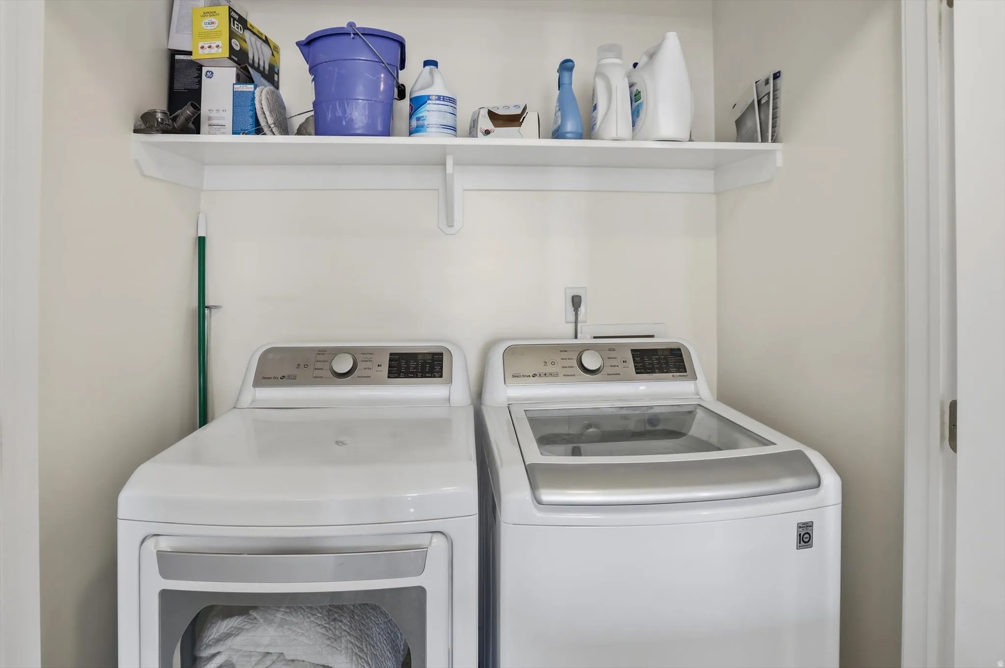 Dedicated laundry area featuring a white built-in shelf