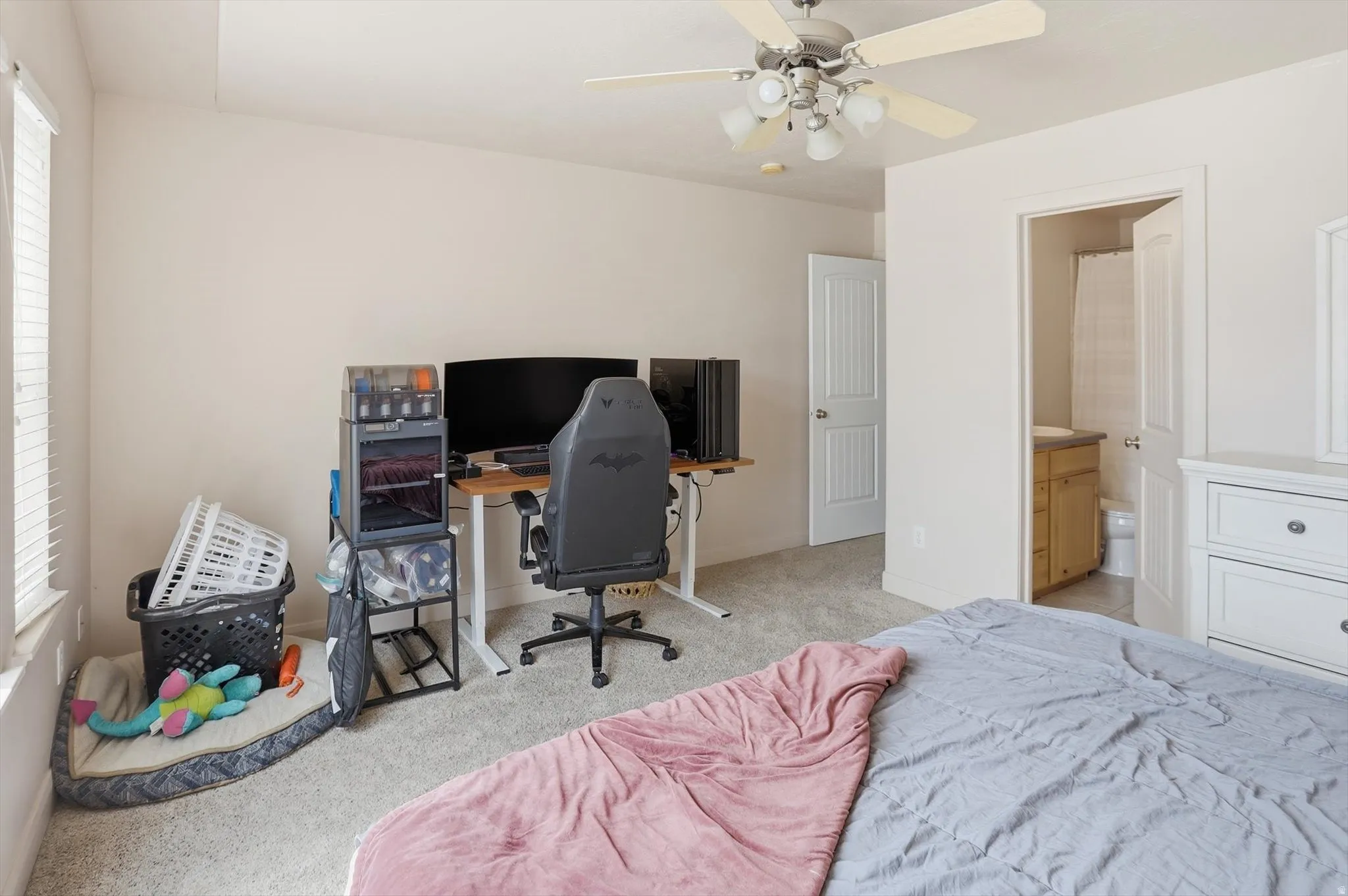 Carpeted room with a ceiling fan, recessed window, and white trim