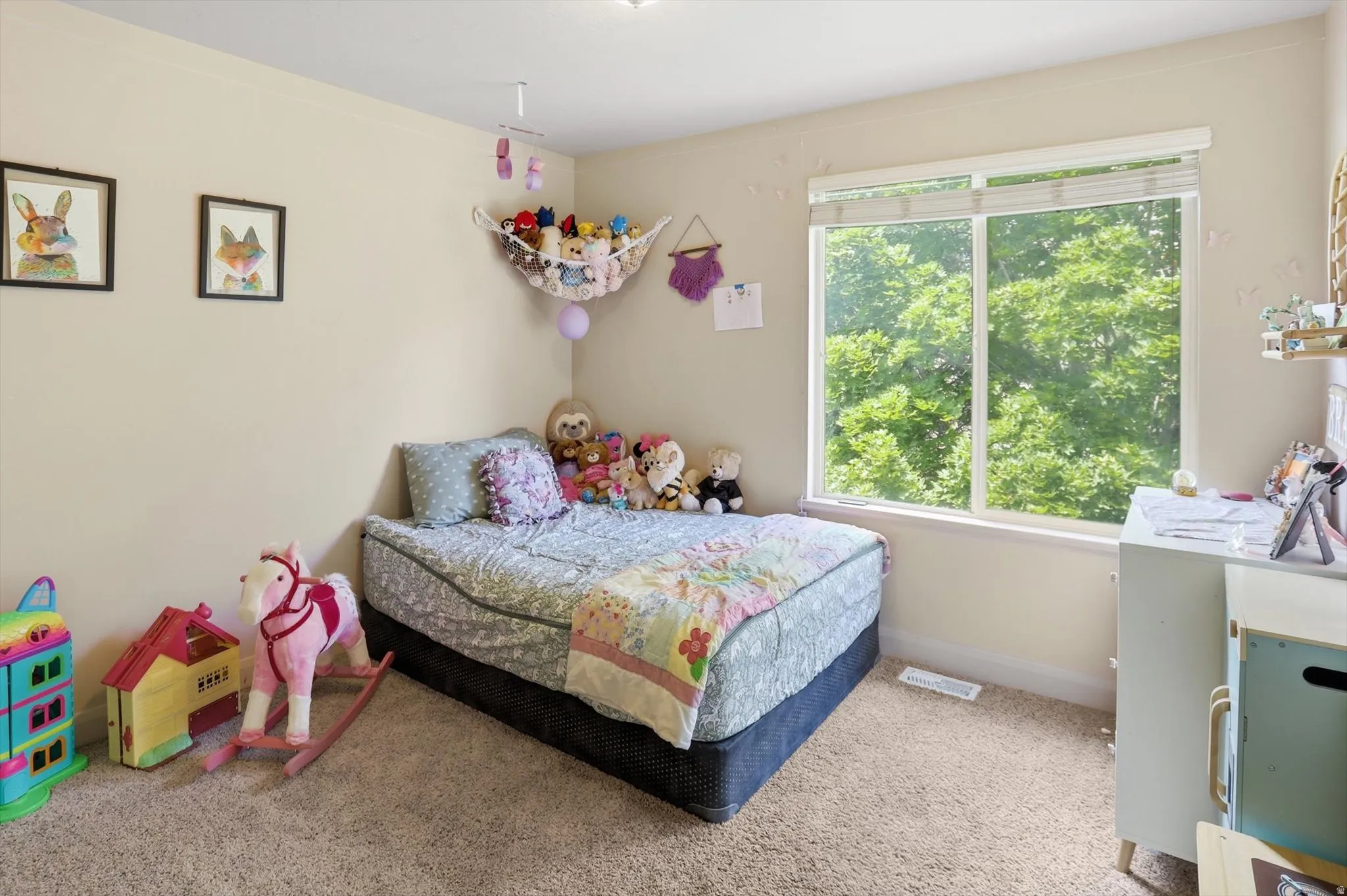 Carpeted room featuring a large window, neutral wall paint, and a built-in ceiling light