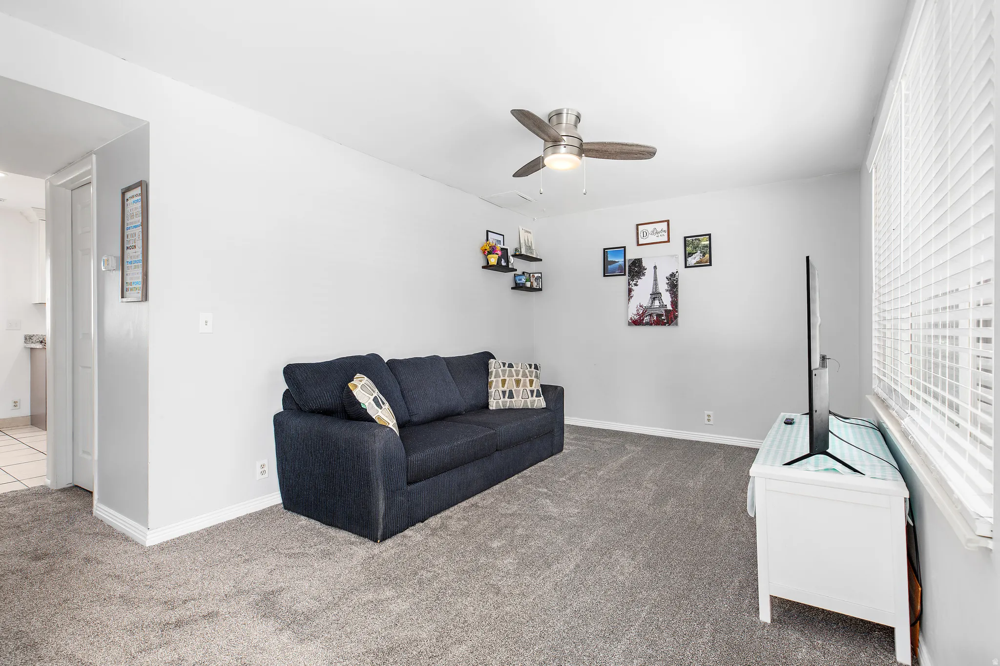 Spacious room with light gray carpeting and neutral wall tones