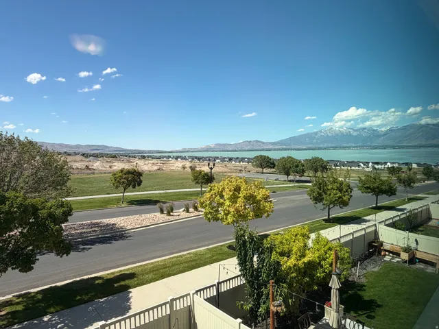 Expansive water body backdrop framed by distant snow-capped mountains