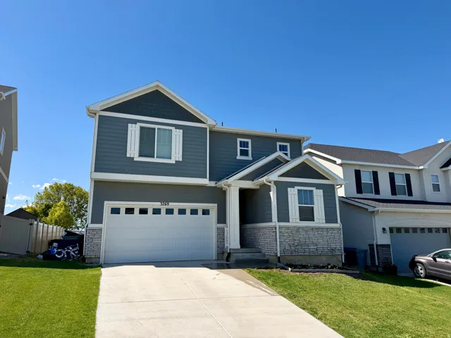 Two-story residence featuring a gray exterior with shingle accents and white trim