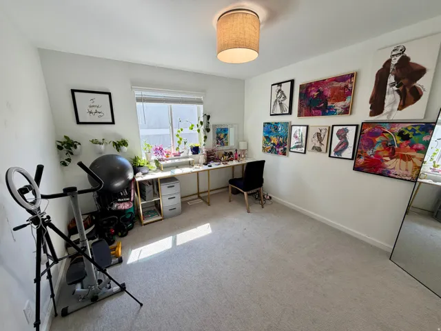 Carpeted room with a window featuring horizontal blinds, a ceiling-mounted drum light fixture, and white painted walls