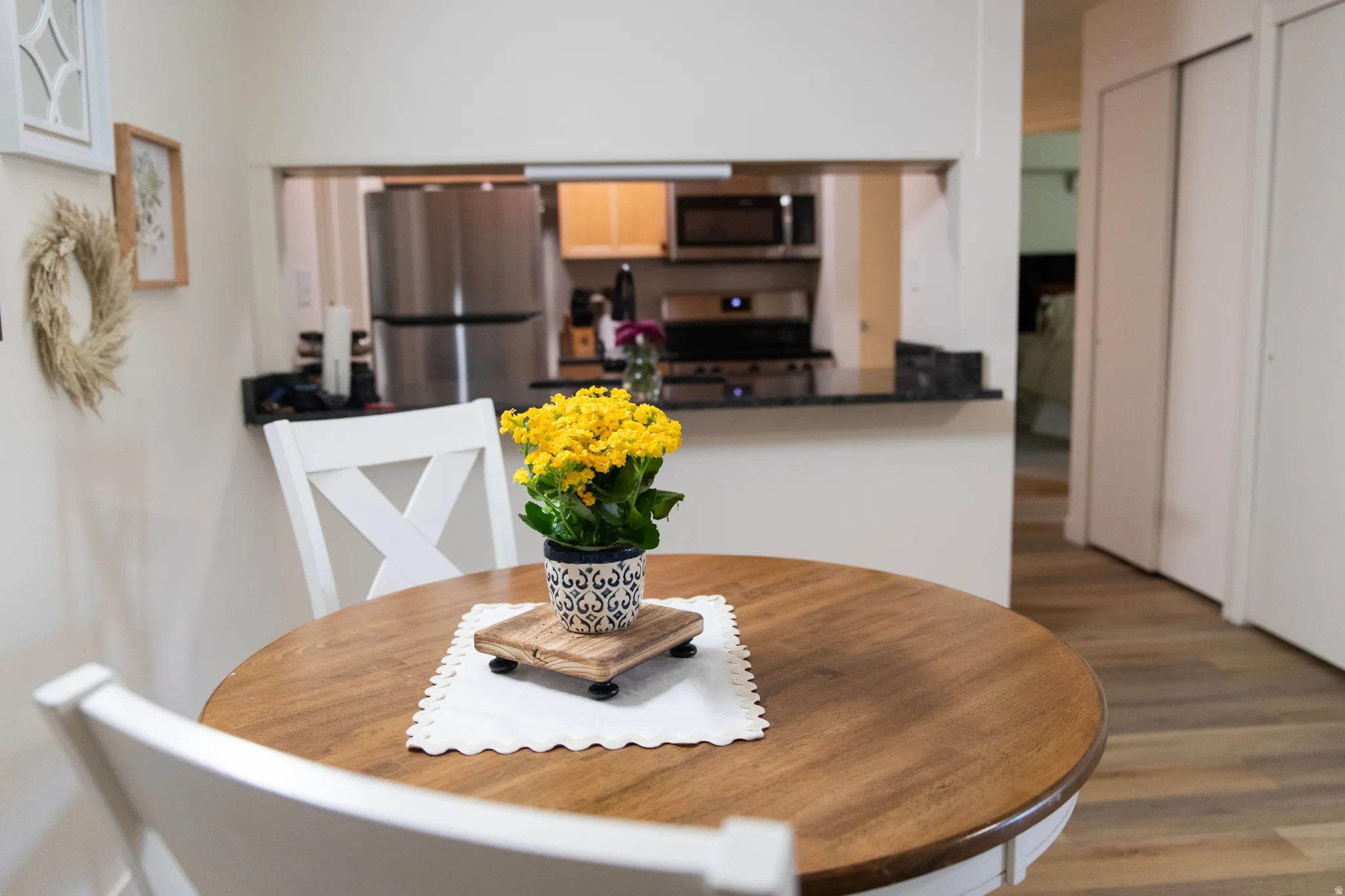Open kitchen pass-through featuring dark stone countertops and stainless steel appliances