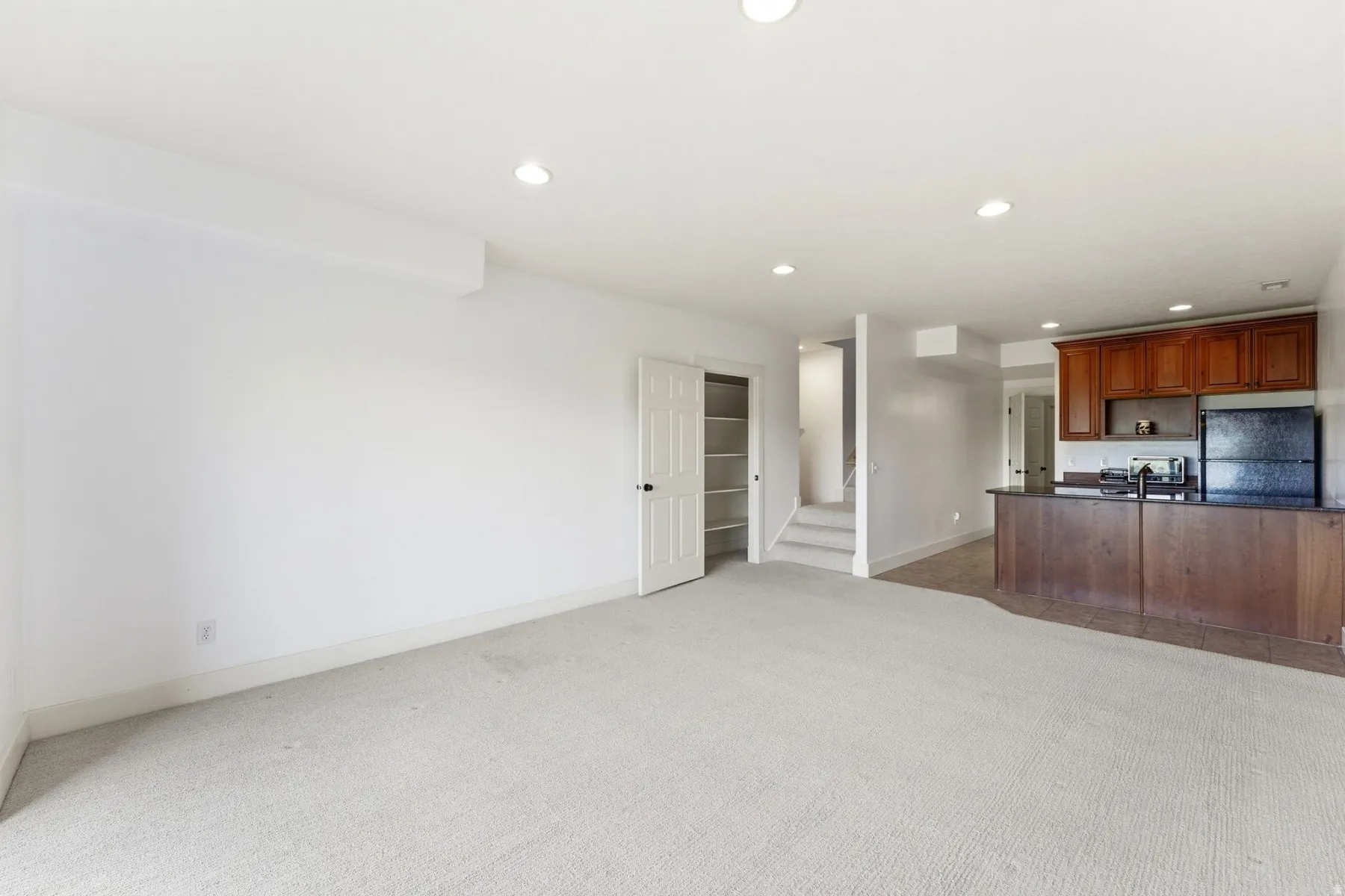 Expansive carpeted area with recessed lighting