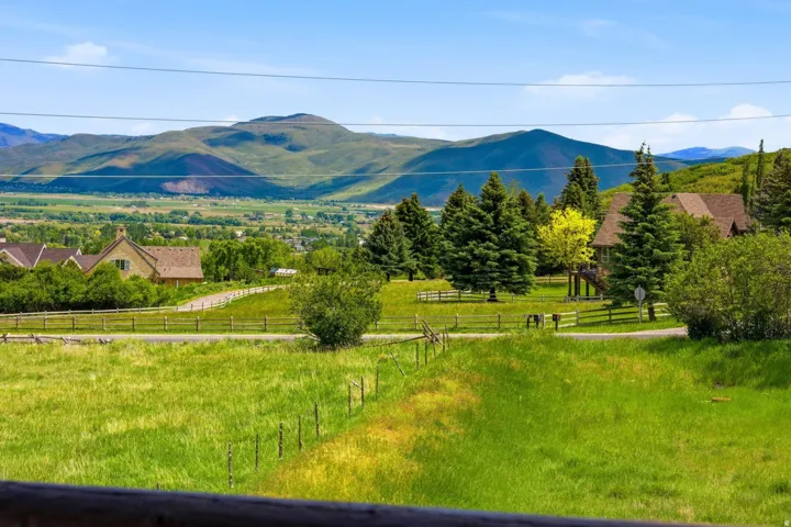 Expansive green landscape featuring rolling hills and distant mountains