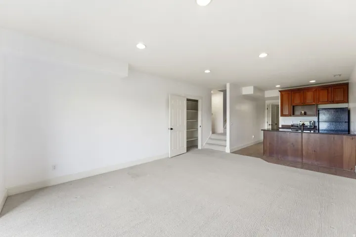 Expansive carpeted area with recessed lighting