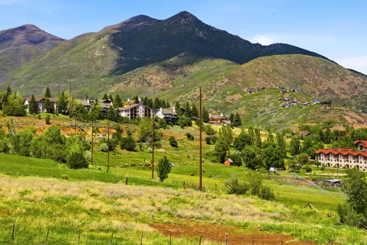 Expansive mountain landscape featuring varied terrain and multiple residential structures