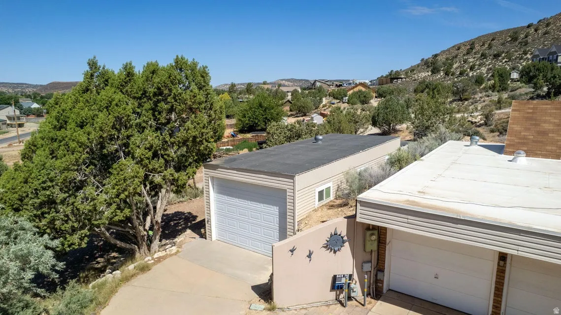 Two separate garage structures featuring overhead doors and horizontal siding