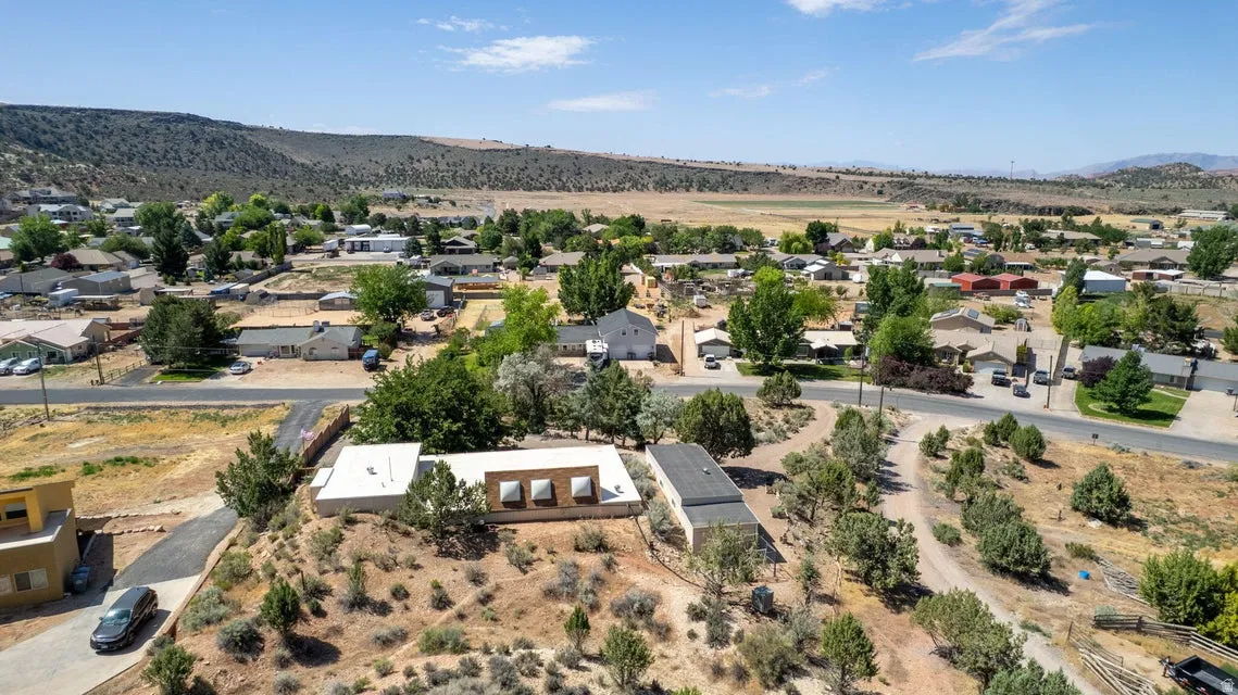 Expansive aerial perspective showcasing a residential community nestled within a valley landscape