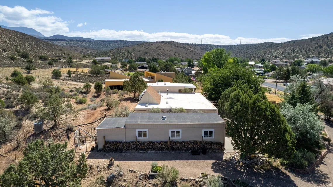 Single-story property featuring a neutral exterior, multiple windows, and a flat roofline