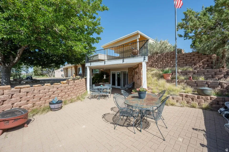 Expansive brick paver patio featuring a tiered retaining wall system